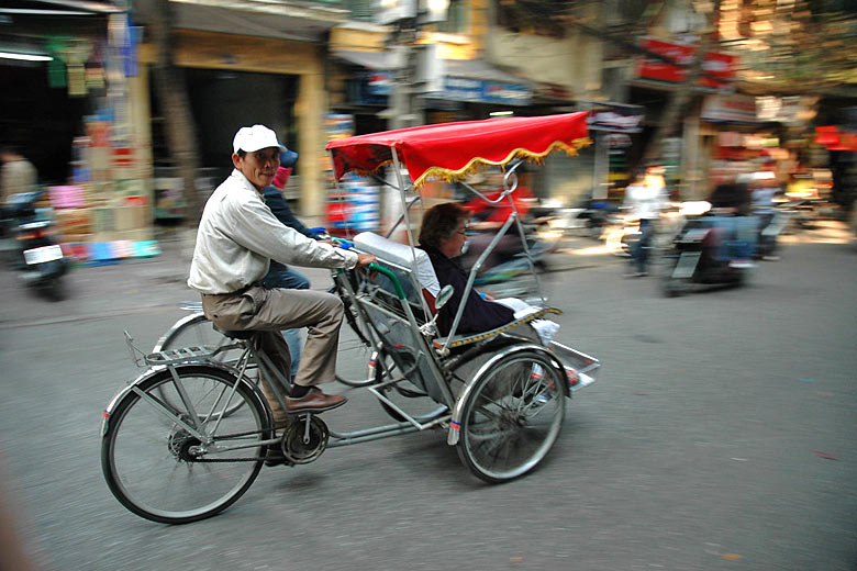 Cyclo on the streets of Hanoi, Vietnam © <a href='https://www.flickr.com/photos/graemenewcomb/342449410/' target='new window o101807' rel='nofollow'>Graeme Newcomb</a> - Flickr <a href='https://creativecommons.org/licenses/by/2.0/' target='new window l101807' rel='nofollow'>CC BY 2.0</a>