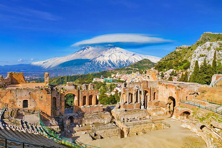 The ancient Greek theatre of Taormina with snow-capped Mount Etna beyond