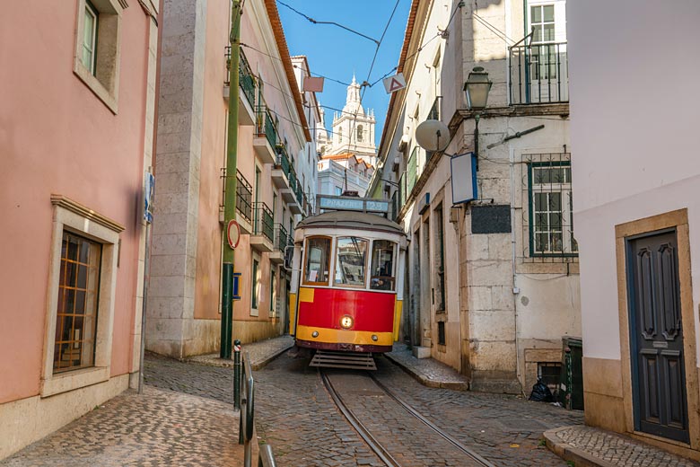Tram 28 negotiating the narrow streets of Alfama, Lisbon © Pawel Pajor - Adobe Stock Image